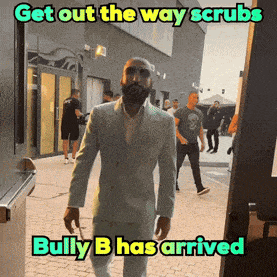 a man in a suit is walking down a street with a caption that says get out the way scrubs bully b has arrived
