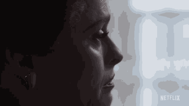 a close up of a woman 's face with the netflix logo visible
