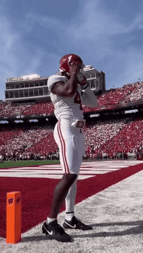 a football player with the number 4 on his jersey stands on the field