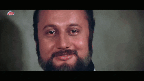 a close up of a man with a beard and the word ultra on the bottom right