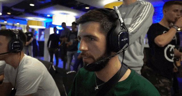 a man with a beard wearing a headset that says astro on it