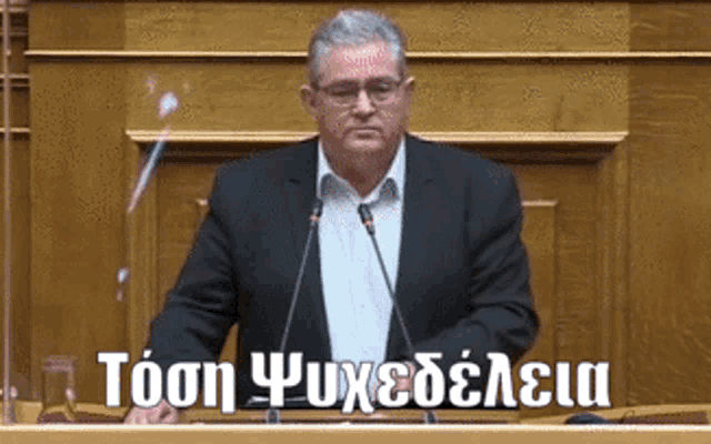 a man in a suit is giving a speech in front of a microphone with the words tosn psychedelia written below him