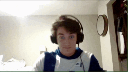 a young man wearing headphones and a shirt that says nike