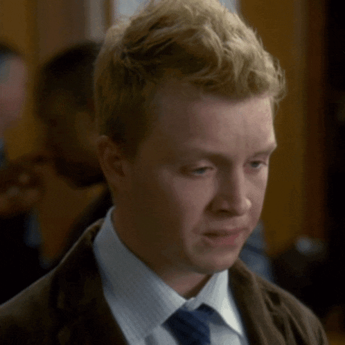 a man in a suit and tie is looking at something