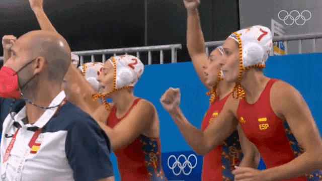 a group of water polo players are celebrating their victory