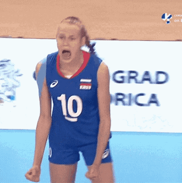 a female volleyball player wearing a blue number 10 jersey