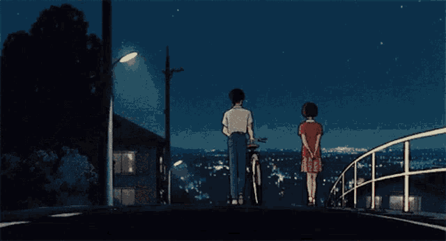 a man and a girl are standing on a bridge looking at the city at night