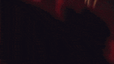 a blurred image of a person 's face with a red and yellow background