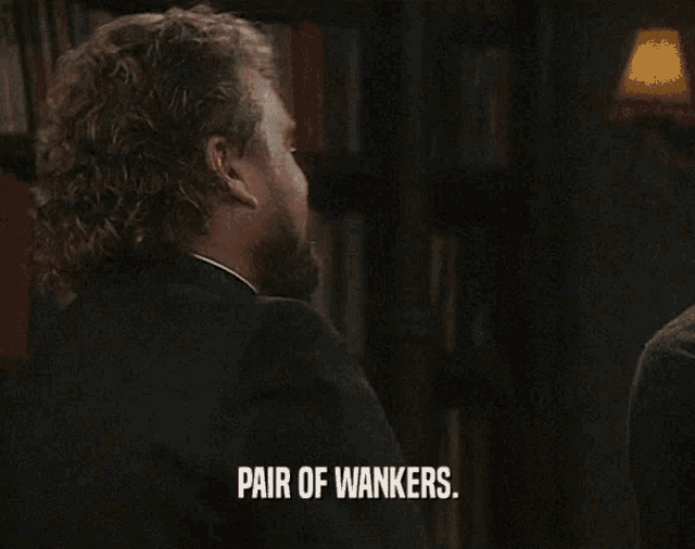 a man smoking a cigarette with the words pair of wankers on the screen