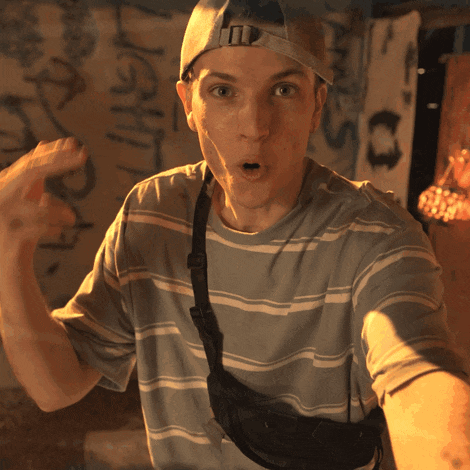 a man wearing a hat and a striped shirt is making a surprised face
