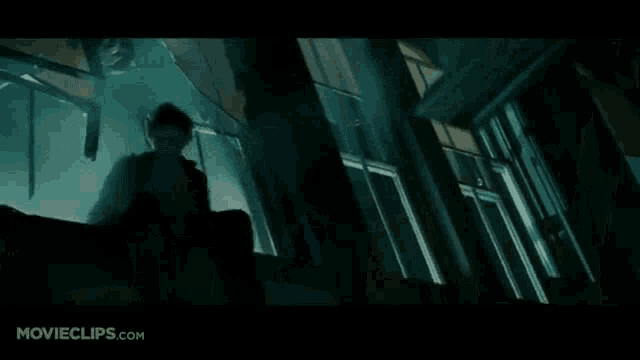 a man is standing in a dark room in a movie clip from movieclips.com