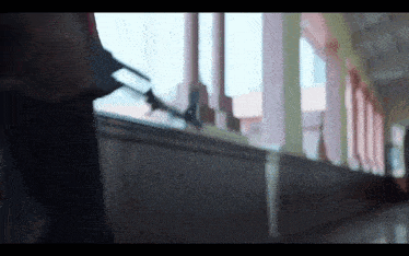 a person walking down a hallway with a gun