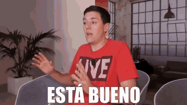 a young man wearing a red shirt that says live on it