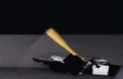a blurred image of a person laying on the ground with a blue and yellow object in the background .