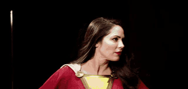 a woman in a red and yellow superhero costume with a lightning bolt on her chest