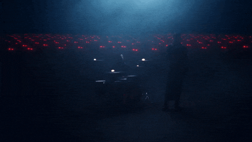 a silhouette of a person in a dark room with red eyes