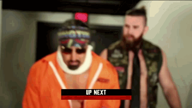 a man with a bandage on his neck stands next to another man with a sign that says " up next "