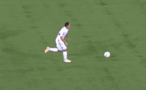 a soccer player with the number 10 on his jersey kicks the ball