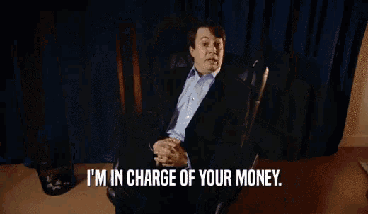 a man in a purple shirt is saying i 'm in charge of your money .