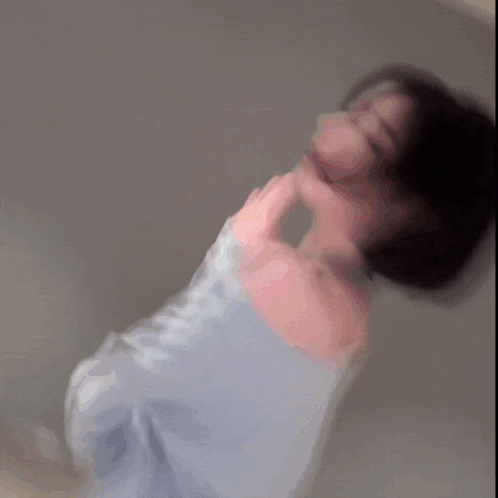 a blurry picture of a woman with short hair waving