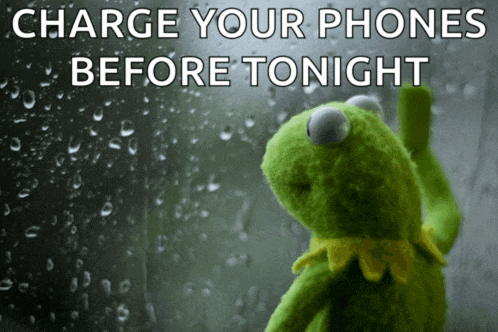 a kermit the frog is looking out a window with the words charge your phones before tonight
