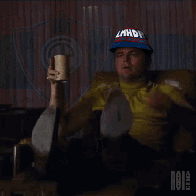 a man wearing a hat that says lmhdp is pointing