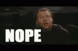 a man is making a funny face and the word nope is on the screen .