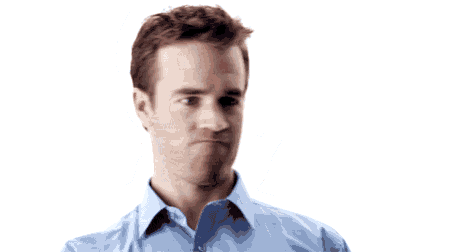 a man in a blue shirt is holding a white object in his hand