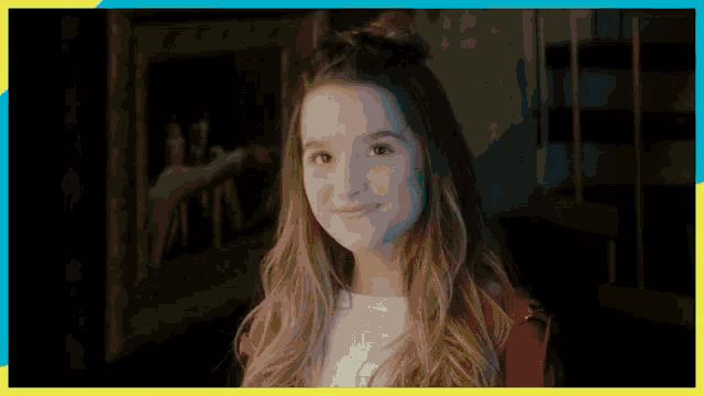 a girl in a red jacket and white shirt is smiling