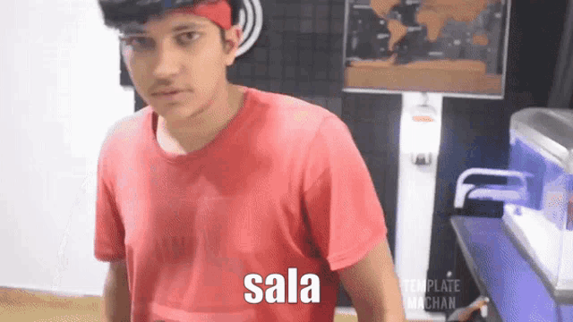 a young man wearing a red shirt with the word sala on the front
