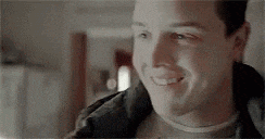 a close up of a man 's face smiling .