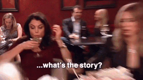 a woman is sitting at a table drinking a martini and talking about the story .