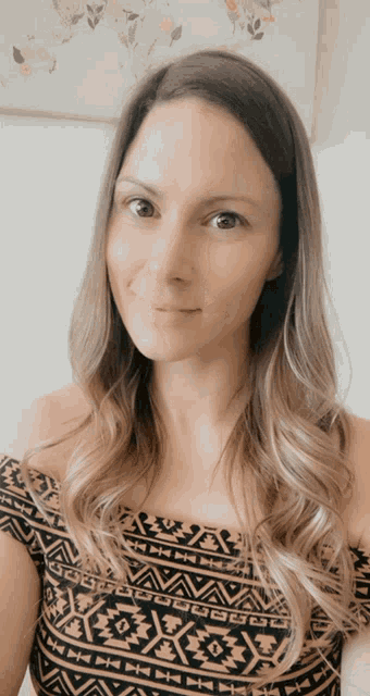 a woman wearing a patterned off the shoulder top