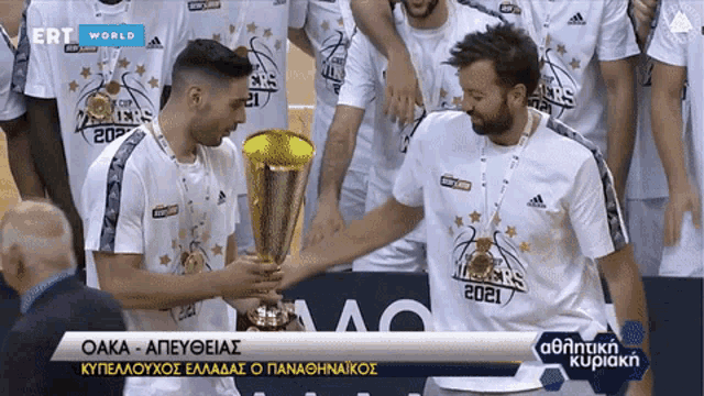 a man holding a trophy in front of a group of basketball players wearing shirts that say ers