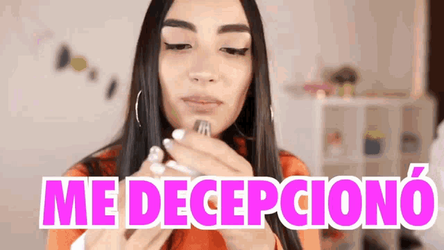 a woman is holding a fork in her mouth with the words me decepciono written above her