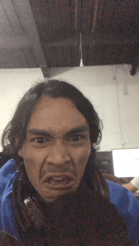 a man wearing headphones makes a funny face with his mouth open
