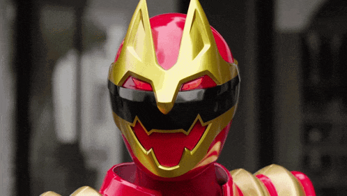 a red power ranger with a gold helmet on