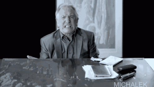 a man sitting at a desk with the name michalek written on the bottom