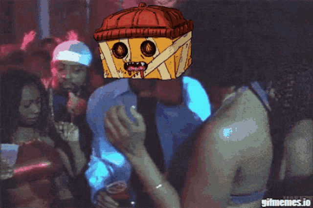 a man wearing a box on his head is dancing in a club
