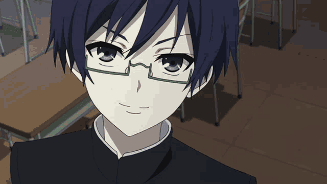a close up of a boy wearing glasses and a black shirt