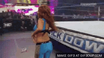 a woman stands in front of a sign that says ' smack down '