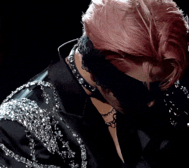 a woman with pink hair is wearing a black jacket and a black lace headband