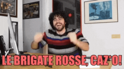 a man sitting in front of a computer with the words le brigate rosse caz * o
