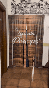 a door with a sign that says la locanda di porcupo on it