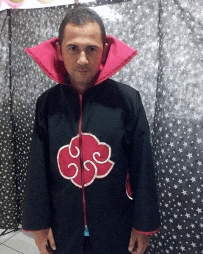 a man wearing a black coat with a red cloud on the front