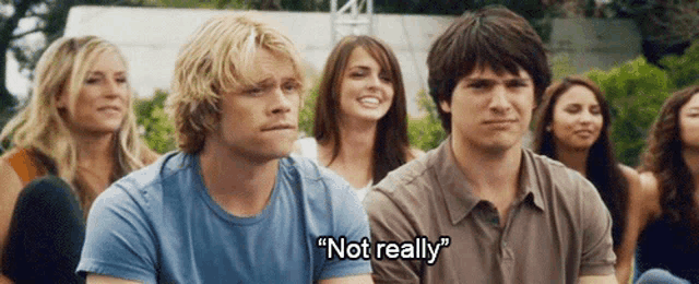 a group of young people are sitting in a circle and one of them is saying " not really "