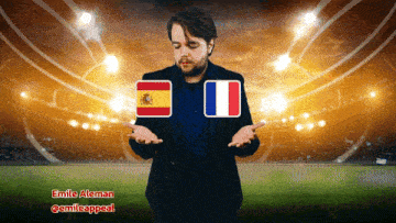 a man standing in front of a stadium with a spanish and french flag