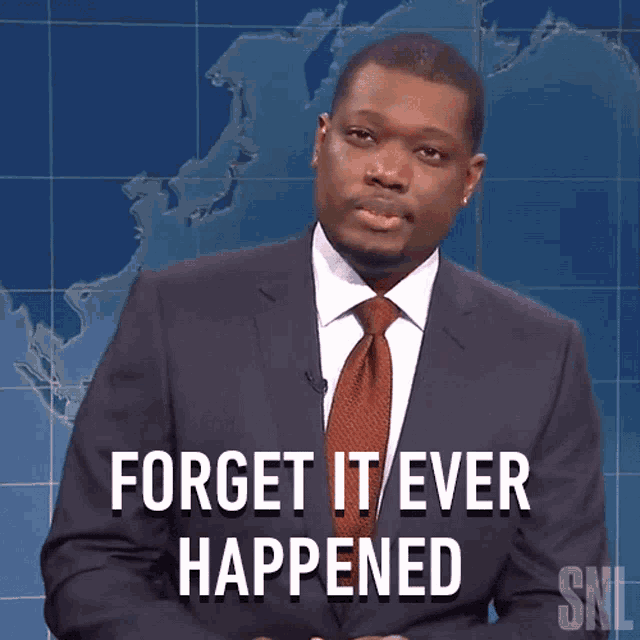 a man in a suit and tie says " forget it ever happened " in front of a map