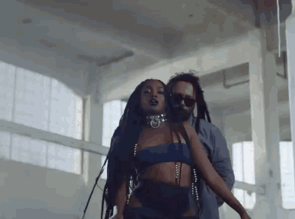 a man and a woman are dancing in a room