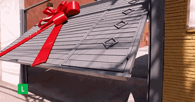 a gray garage door with a red ribbon on it